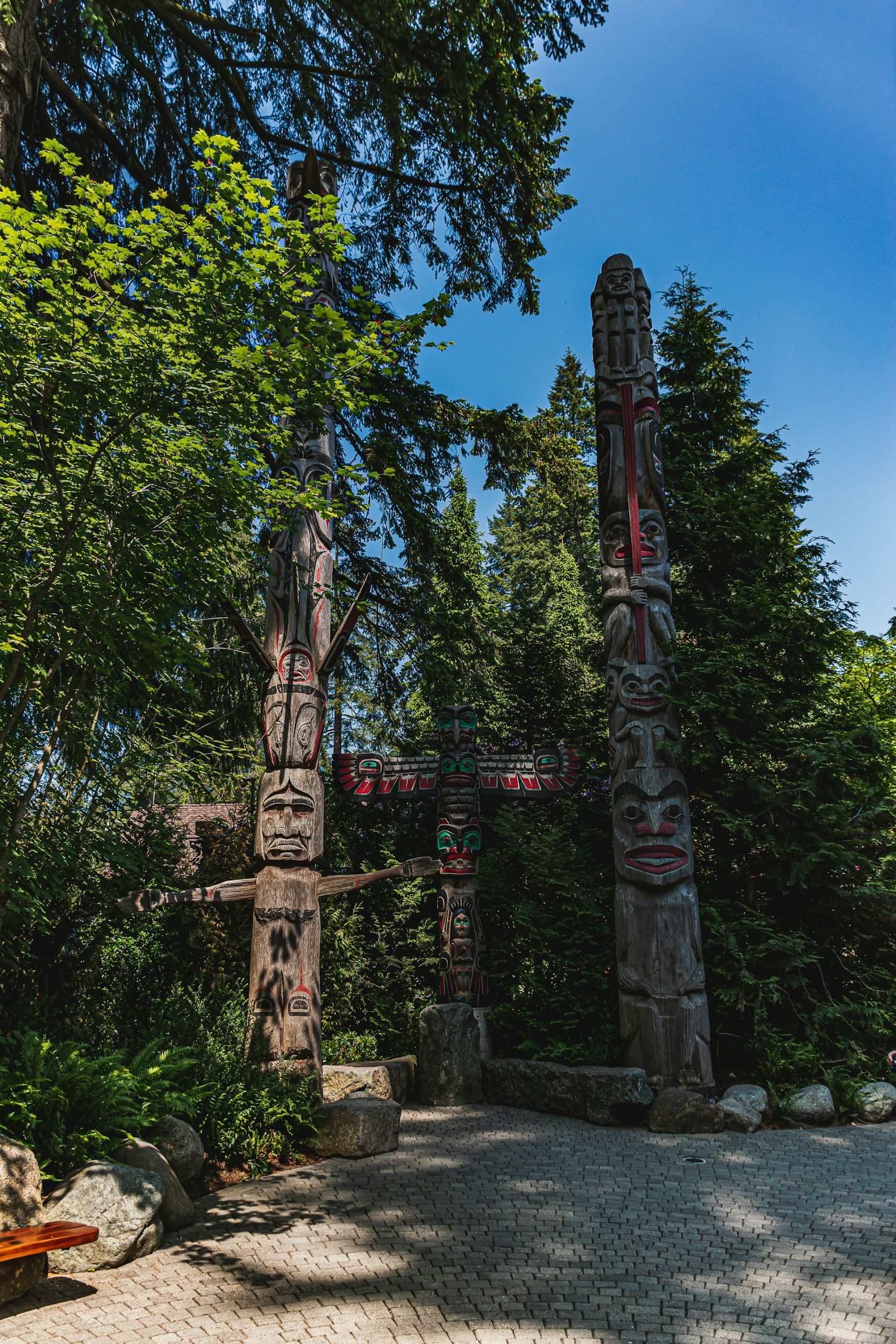 brown wooden statue surrounded by green plants